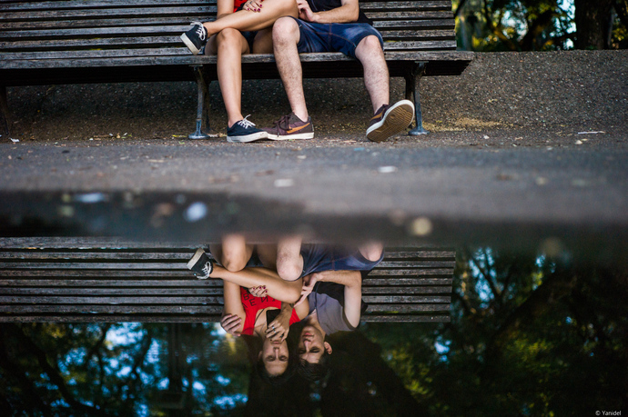 A reflection of lovers look at a smartphone 